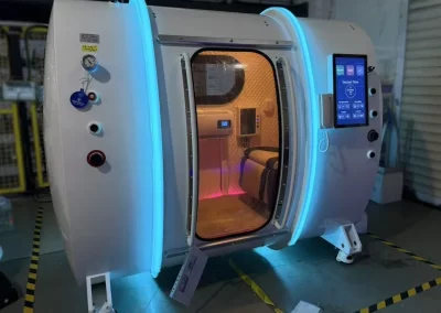 Oval walk-in hyperbaric chamber - door side view with lights on inside